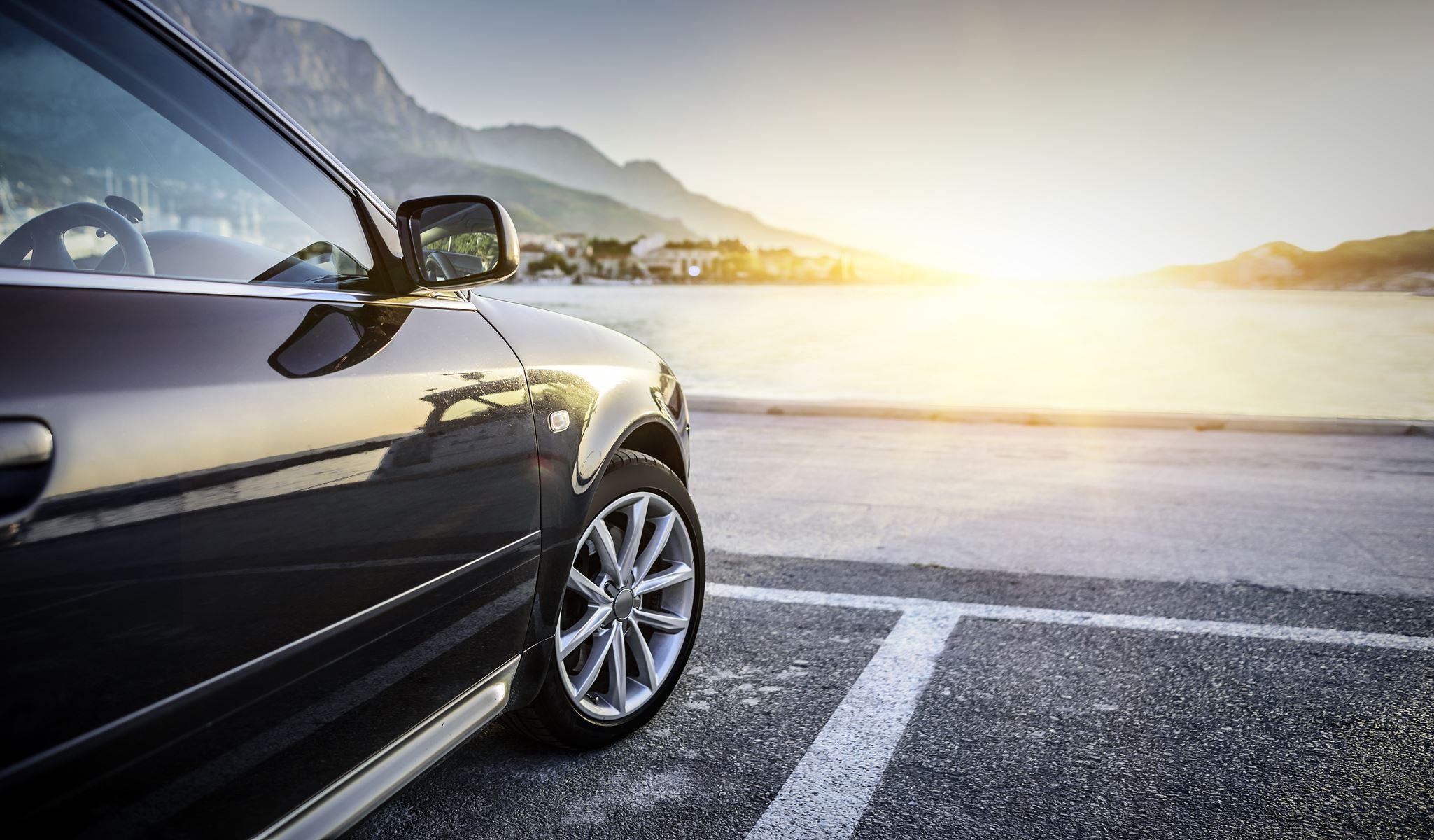 car parked over looking the ocean during sunset