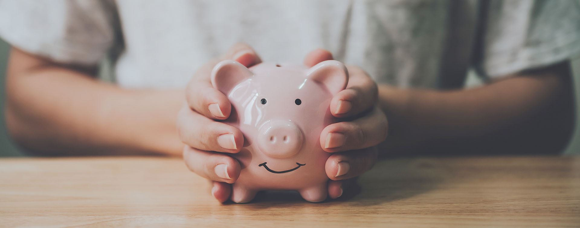 Hands holding a piggy bank