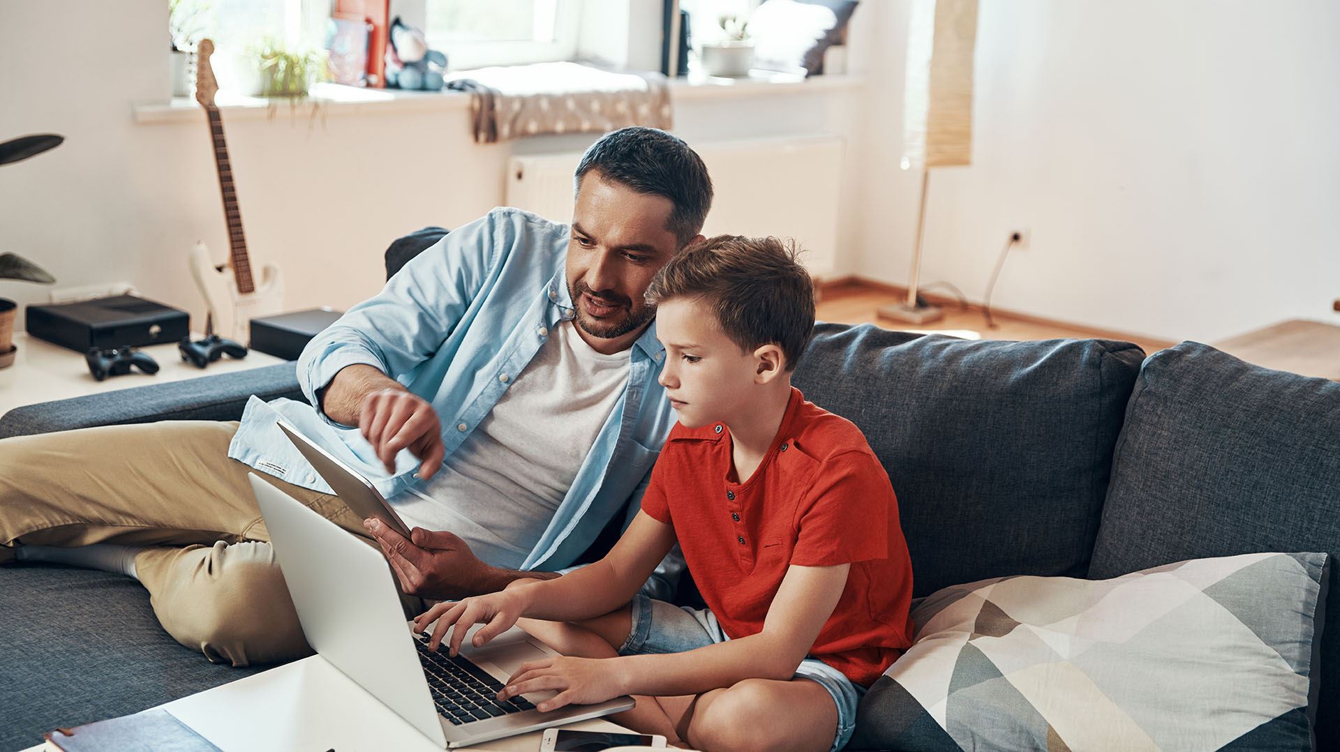 father and son working on a computer