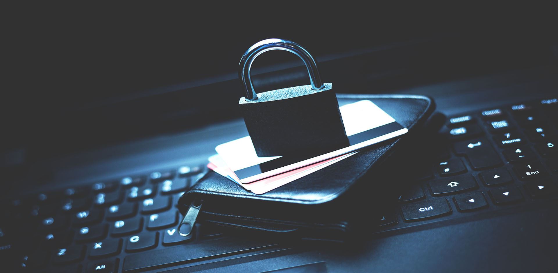 padlock sitting on top of credit cards and a wallet