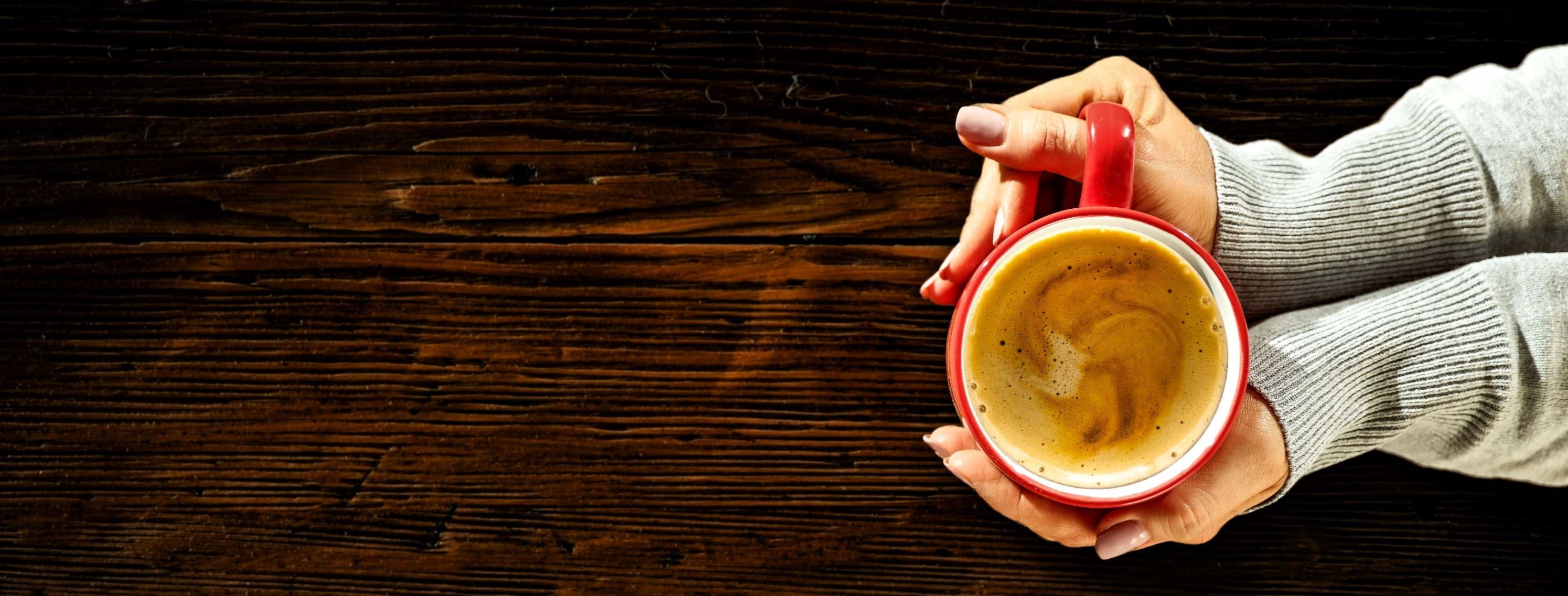 woman holding coffee cup